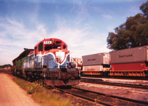 The Delaware & Hudson's engine 506 was painted in a Bicentennial commemorative scheme in 1976. Morrison-Knudsen rebuilt this RS3M locomotive in the mid-70s, creating a rather odd chopped nose. A NYSW Sea-Land stack train passes in the background. East Binghamton Yard, Conklin, N.Y. sometime in 1988.